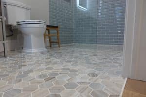 Image of a walk-in shower with grey tile. 