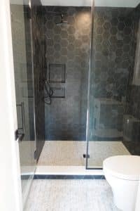 Walk-in shower with white tile.